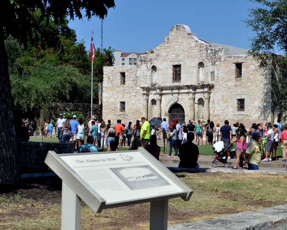 The Alamo, near the San Antonio River Walk, with crowds of people standing outside