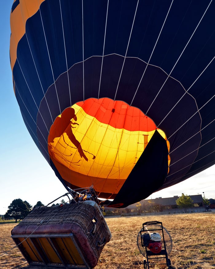 Hot Air Balloon almost fully inflated with a fan blowing the hot air into the balloon