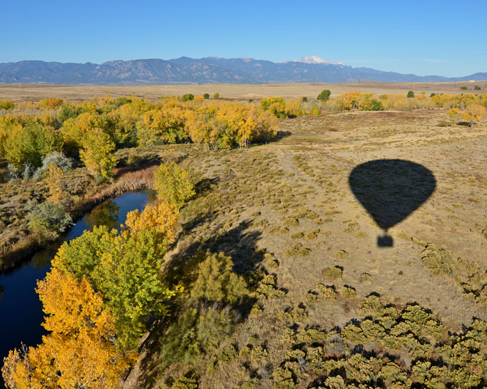 Shadow of Hot Air Balloon over a lake and plains in Colorado Springs
