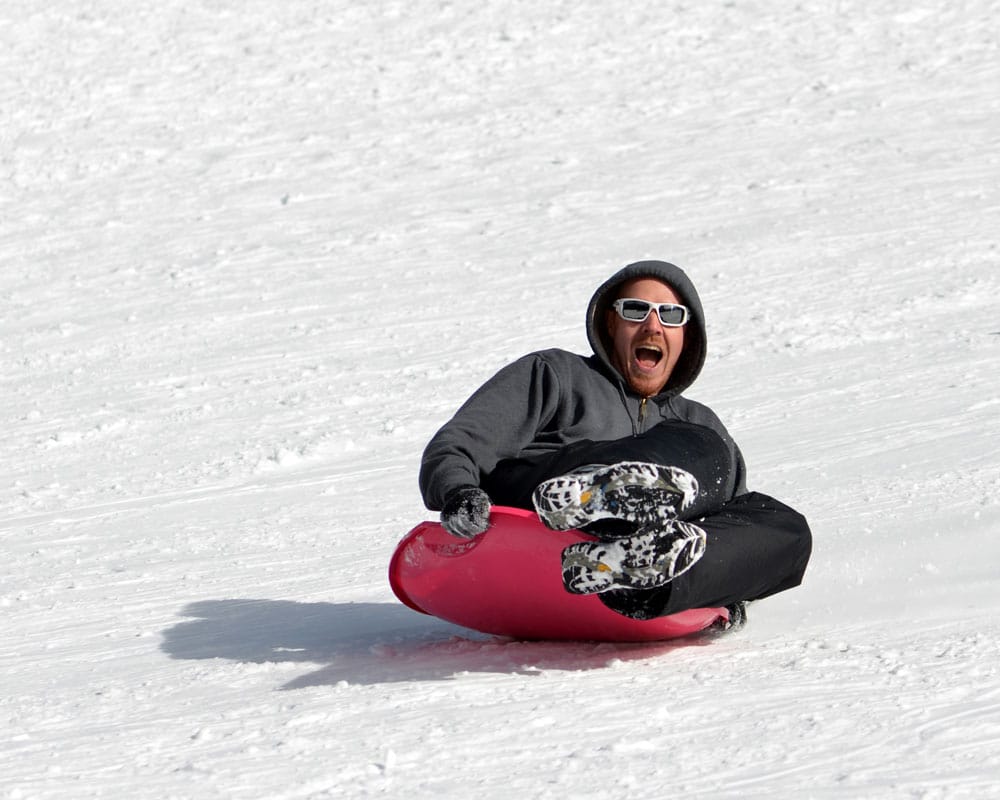 Buddy Sledding down the sledding hill in Hidden Valley