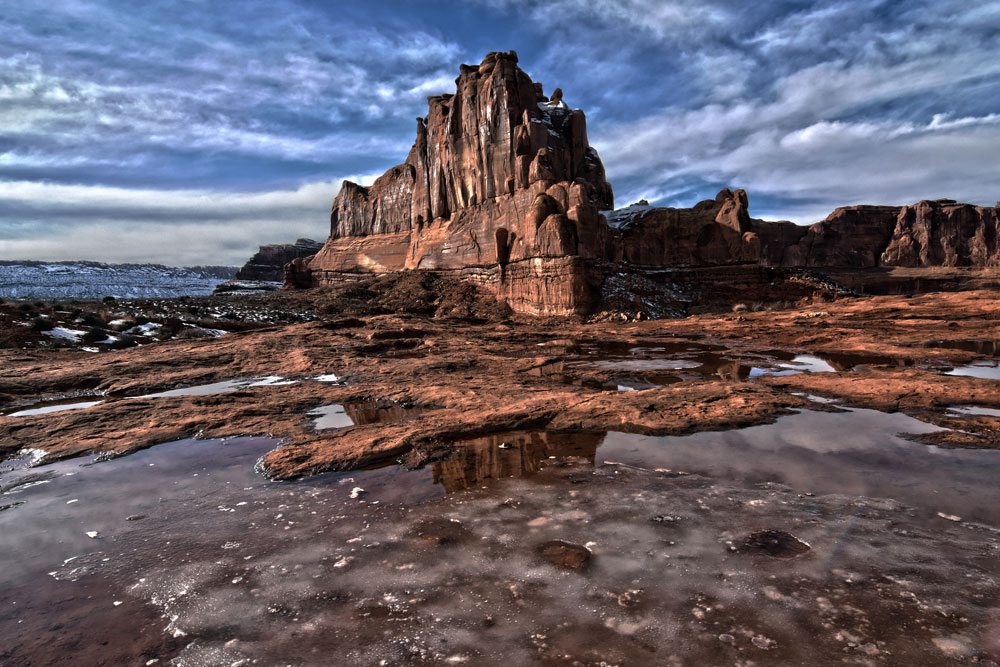 Icy pools of water in the red rocks in Arches National Park