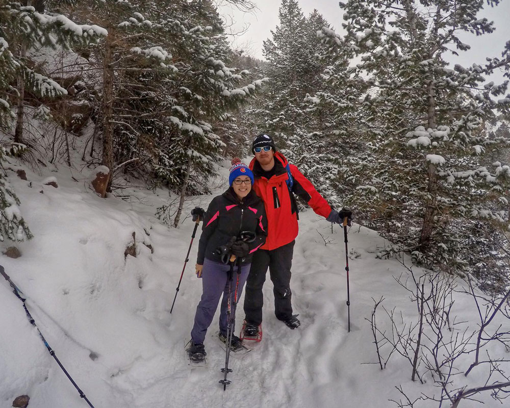 Snowshoeing on a snow packed trail in all of our winter essentail
