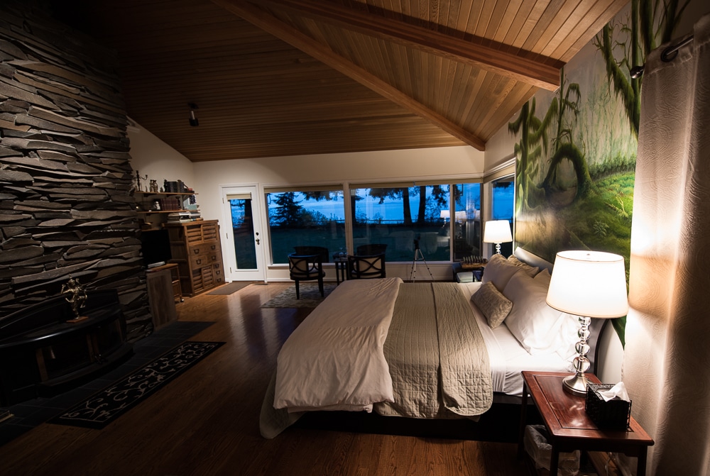 The beautiful Hoh Rainforest Suite at Domaine Madeleine with floor to ceiling windows looking out to the back garden.