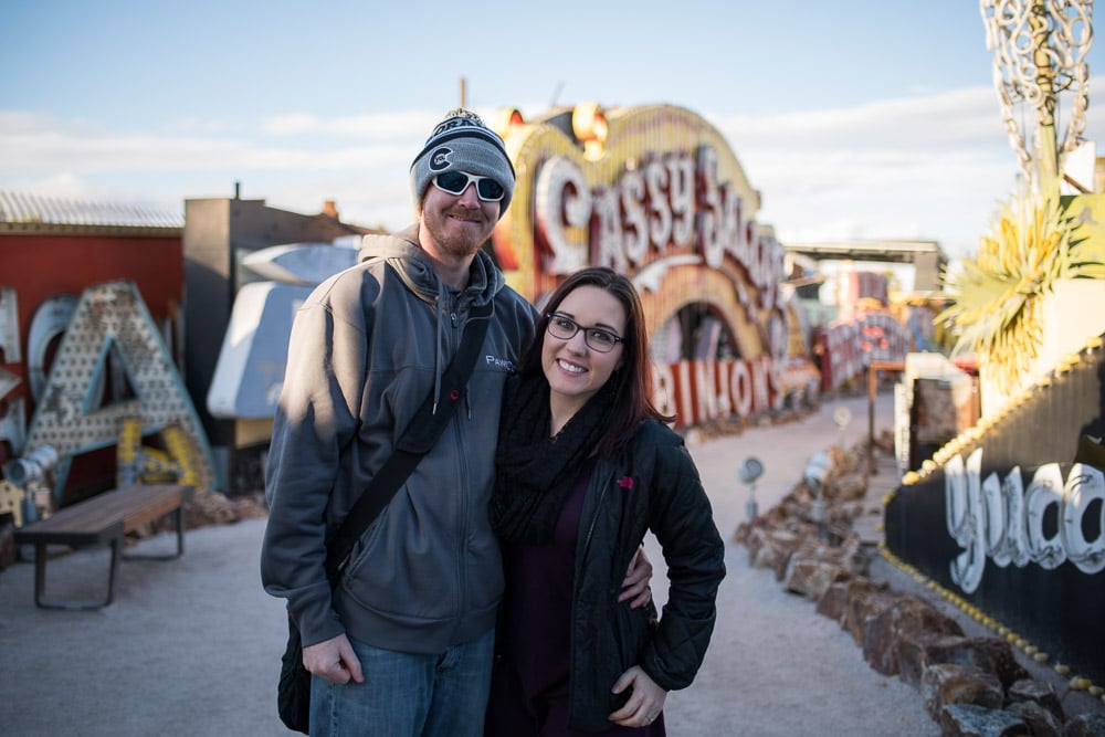 Brooke and Buddy posing near some of the old signs at the Neon Museum - sober things to do in las vegas for non-gamblers