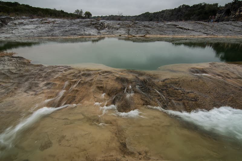 Water flowing over limestone into a larger lake in Pedernales Falls State Park
