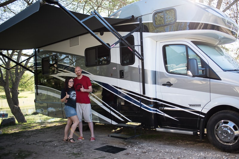 Brooke and Buddy posing outside their new Winnebago View