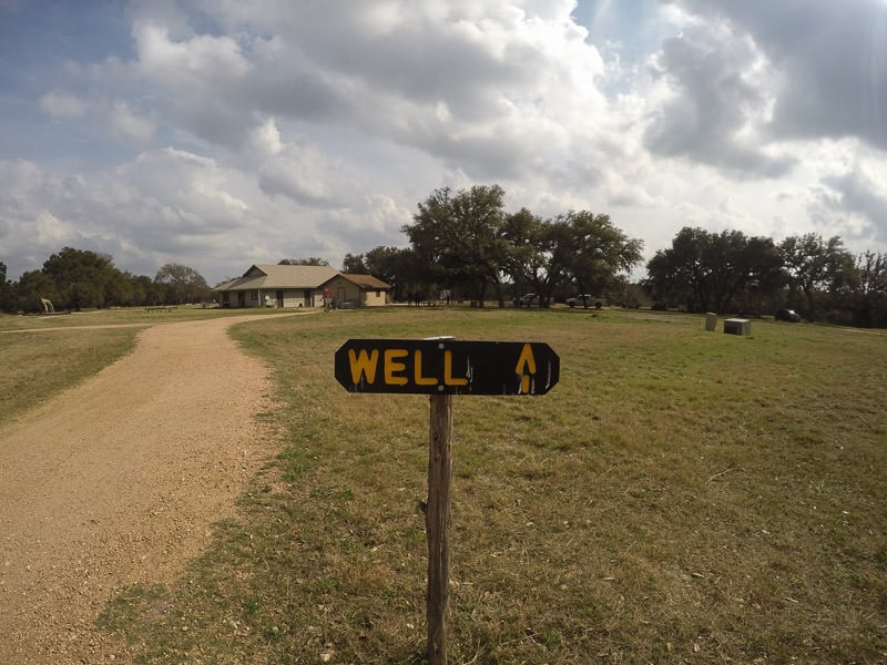Just a simple sign that says 'Well' and an arrow