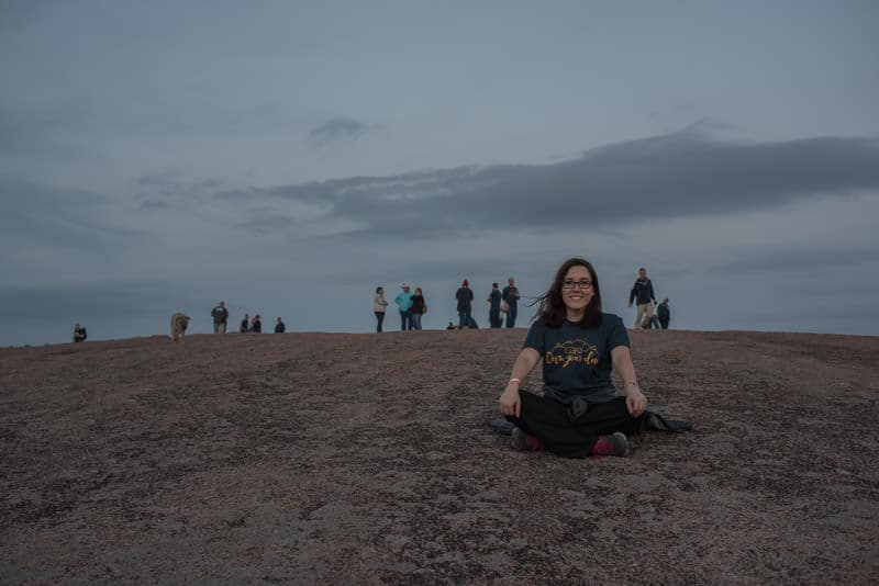Brooke sitting atop Enchanted Rock during our group hike during RVE Summit 2017, Texas
