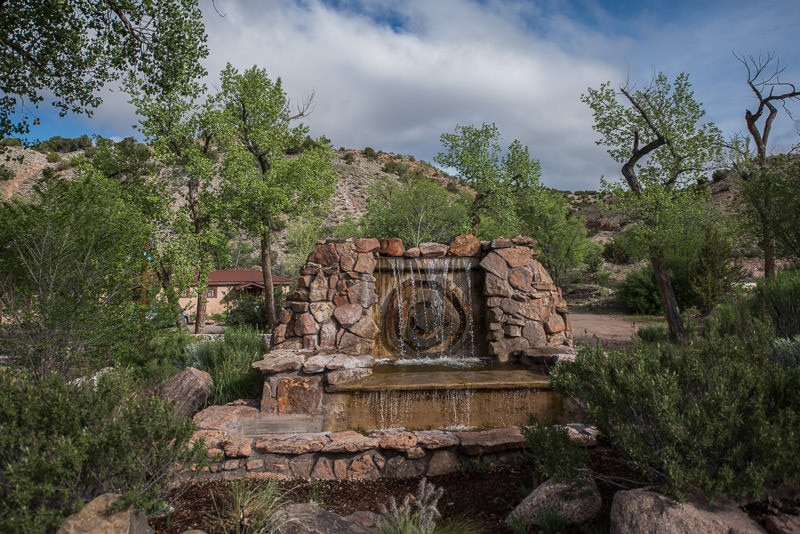 waterfall and sign at entrance to Ojo Caliente Mineral Springs & Spa