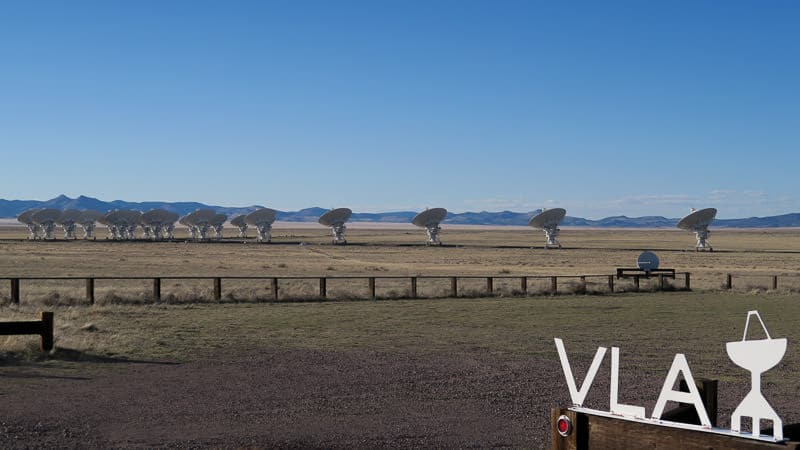Looking out on the field where the satellites are with the VLA sign in the foreground