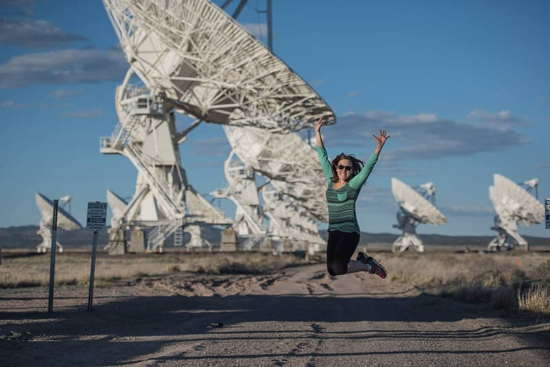Brooke jumping for joy in front of the huge satellites at the very large array, new mexico