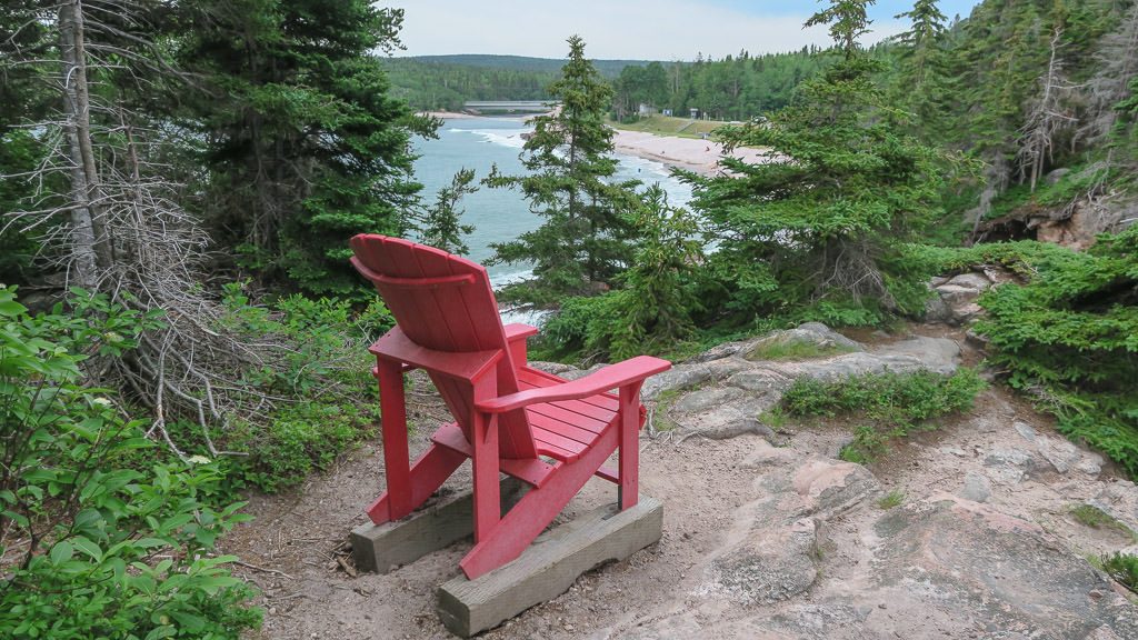 Red Chair overlooking a gorgeous view found on a small hike in cape breton highlands in Nova Scotia