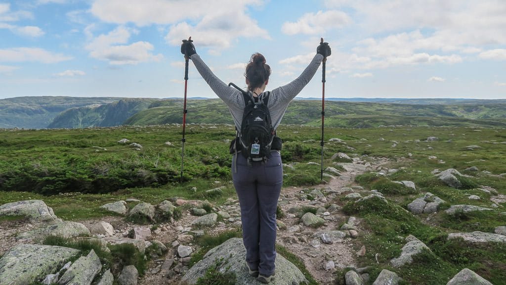 Brooke raising her arms at the top of Gros Morne Mountain