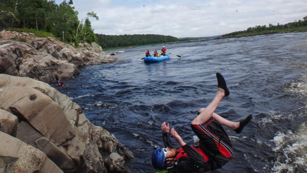 Buddy flipping off the cliff into the Exploits River during our Newfoundland tour