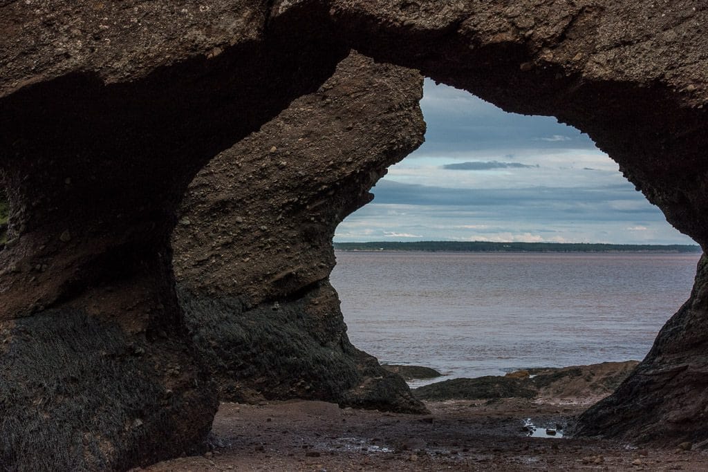 Looking through some of the arches in Hopewell Rocks during low tide