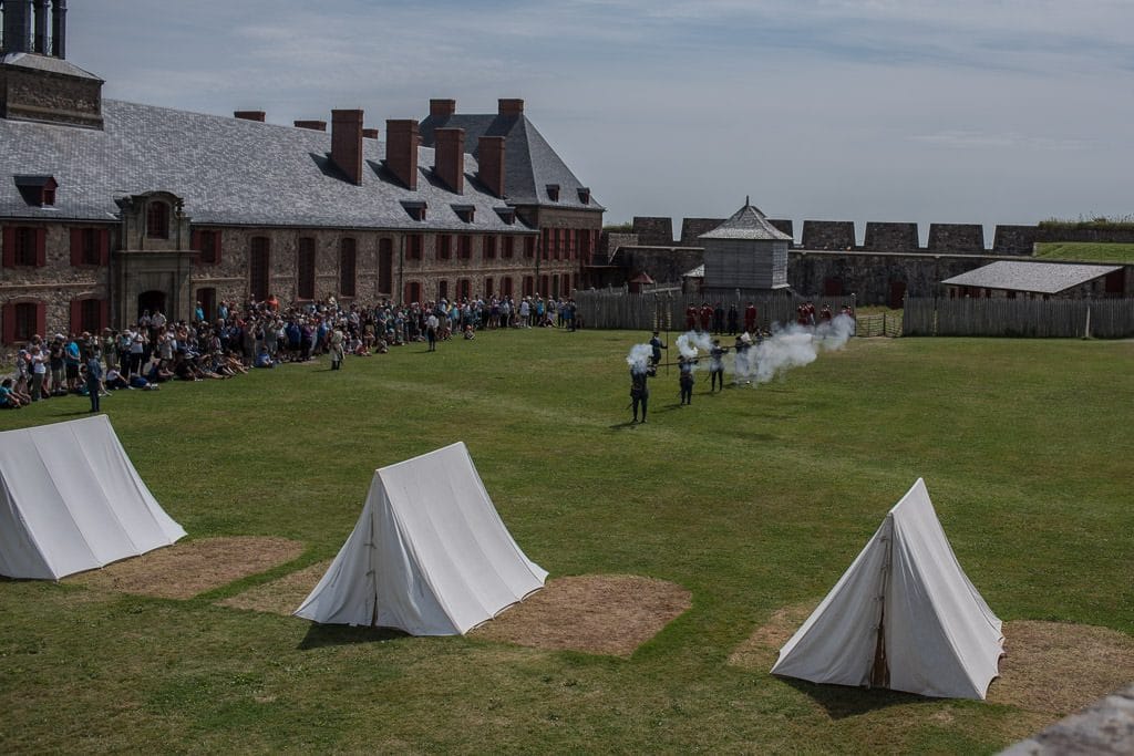 firing of the muskets in the field during the military pageantry at Fortress of Louisbourg