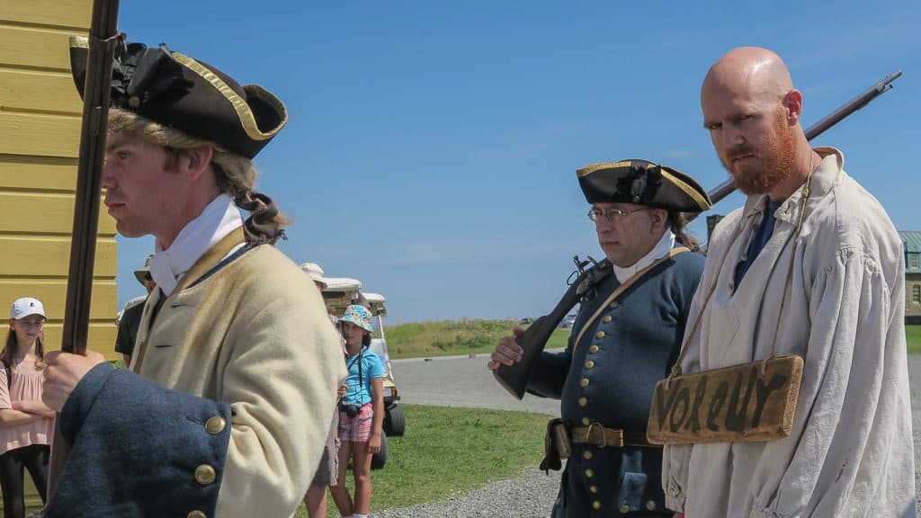 Buddy being paraded through town with armed guards surrounding him during his time as Prisoner of the Day