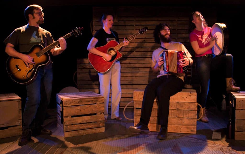 Performers playing instruments at the Gros Morne Theatre Festival