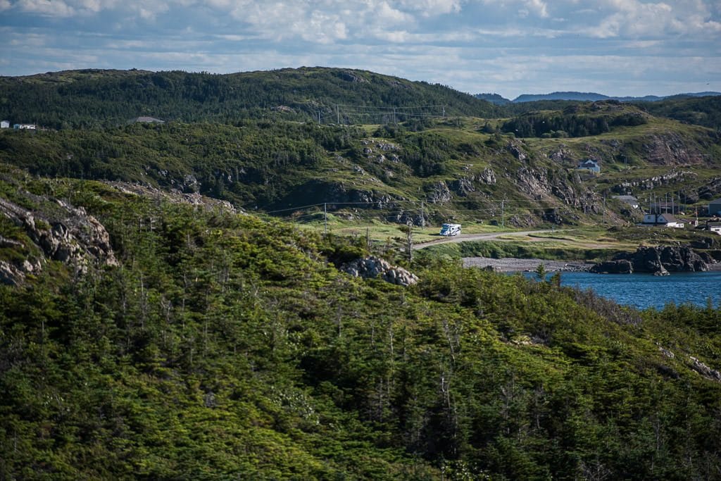 View of our RV at an epic boondocking spot from a hike to the edge of the cliffs.