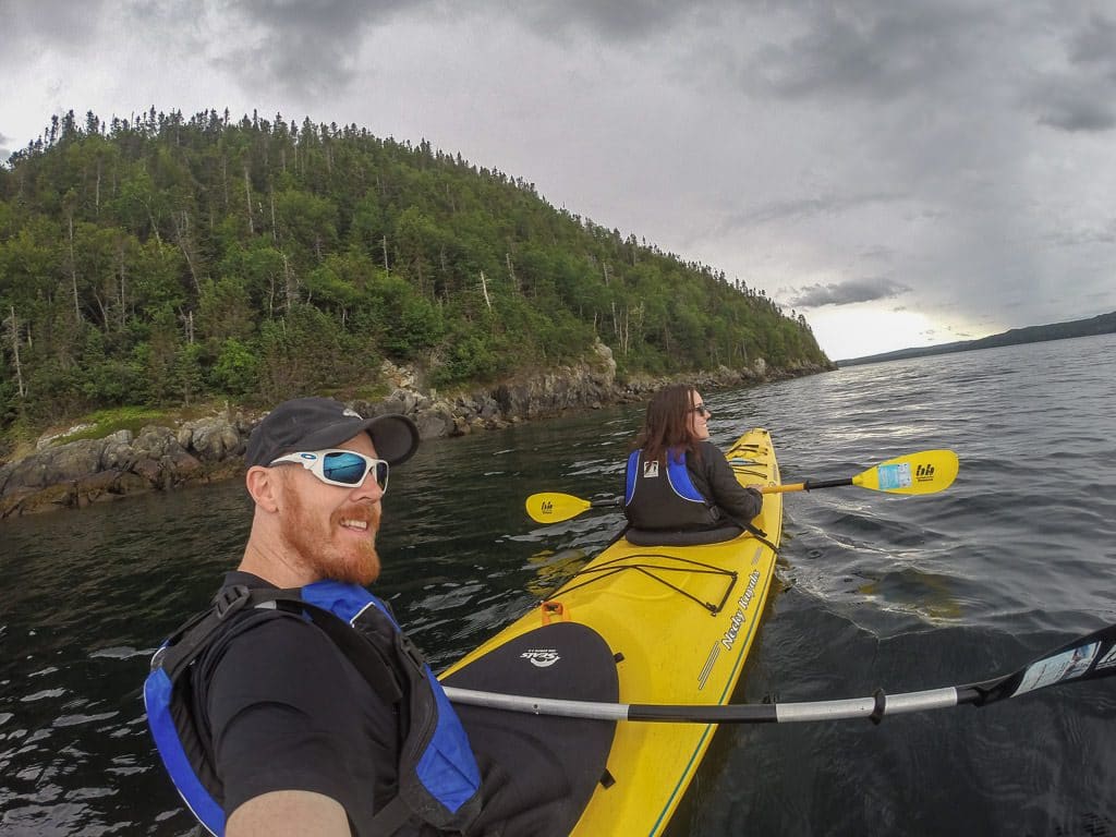 Brooke and Buddy in a kayak out on the water while Exploring Terra Nova National Park