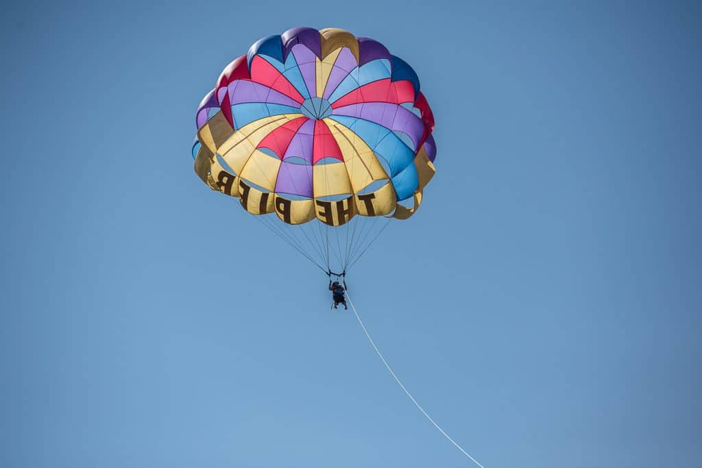Brooke up in the sky during her Parasailing adventure with Inn at the Pier