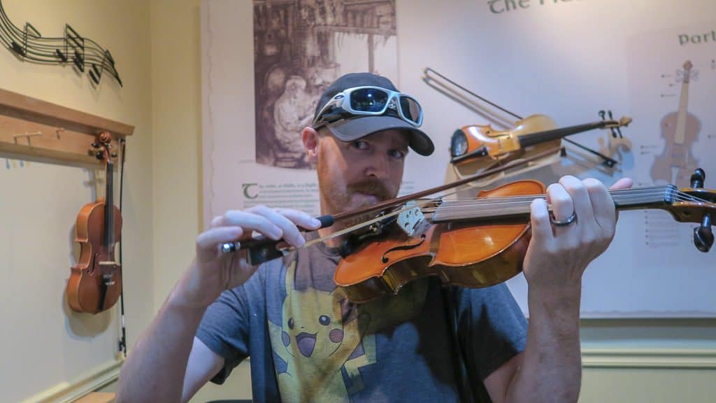 Buddy playing a fiddle while at the Celtic Music Interpretive Centre