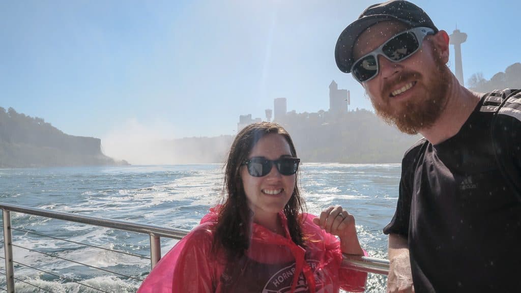 Brooke and Buddy posing on the Hornblower Niagara Cruise, one of the top things to do in Niagara Falls