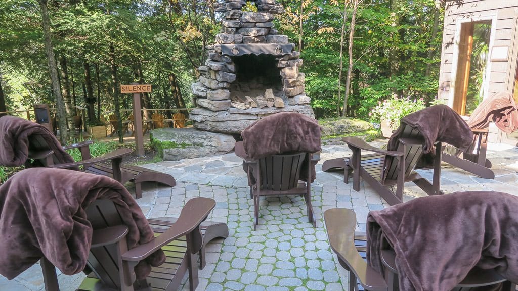 Relaxing sitting area near a fireplace to relax at after a cold hydrotherapy dip