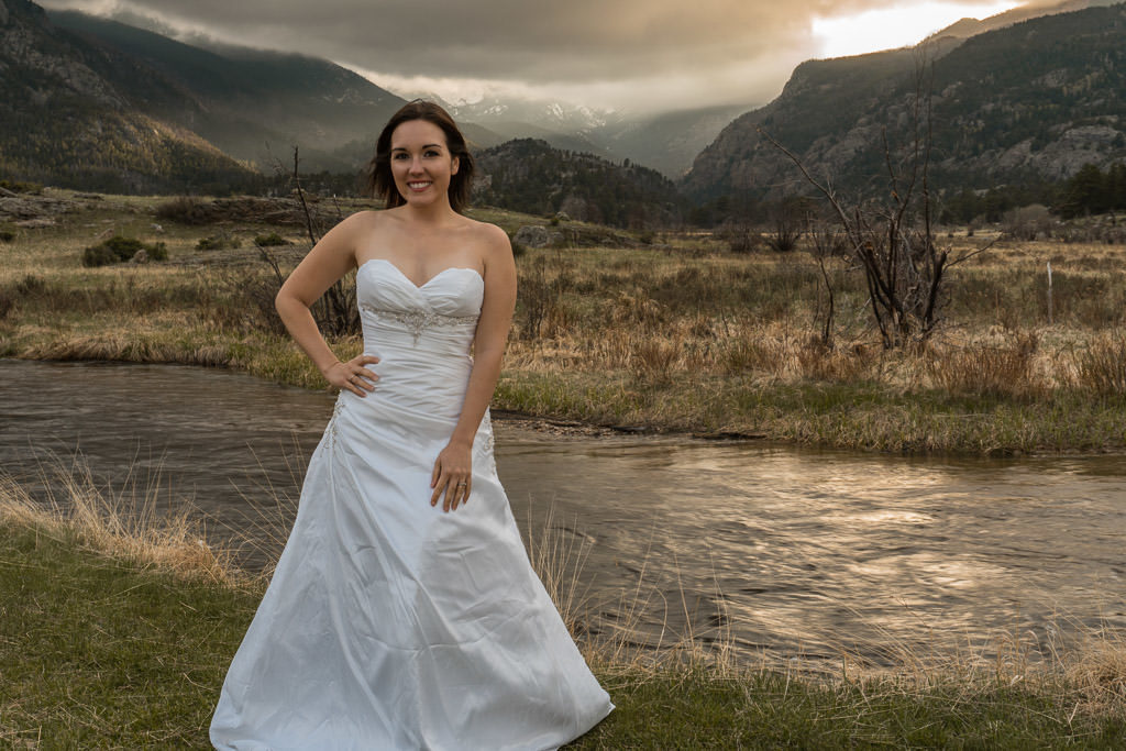 bride photo for rocky mountain vow renewal with sunset through mountains