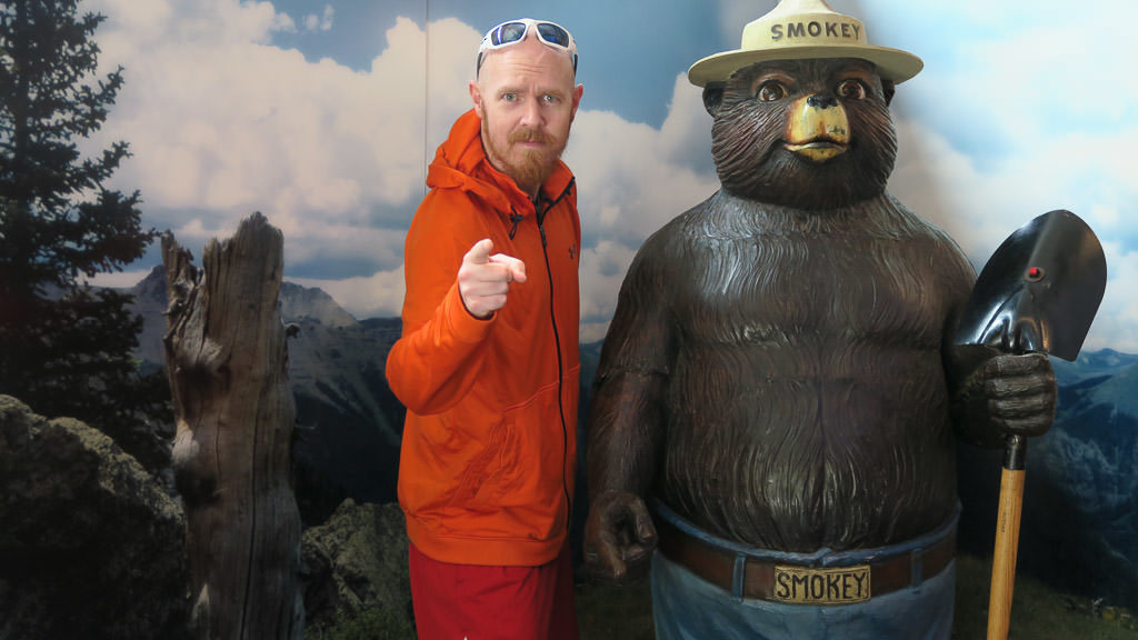 Buddy next to a large Smokey Bear statue at Smokey Bear Historical Park