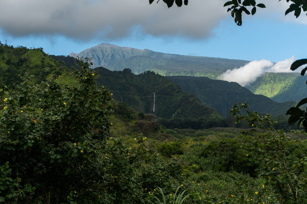 Waterfall in the distance with mountains all around at the Wailua Overlook
