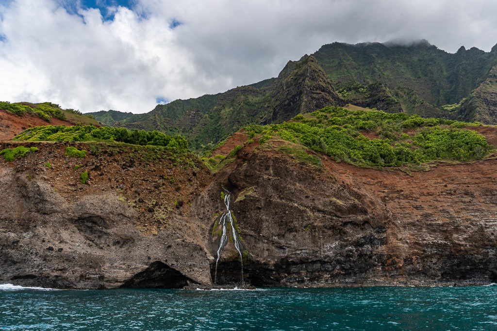 mini waterfall and mountain views on napali coast boat tour