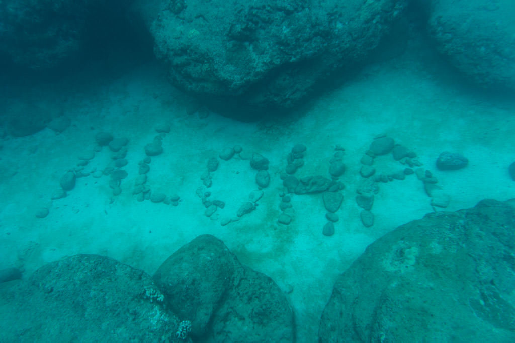 aloha written in stones on ocean floor photographed when snorkeling in oahu