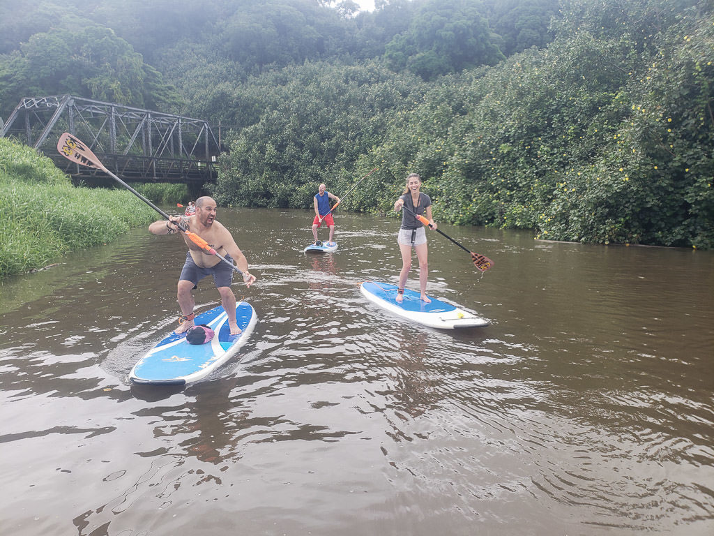 paddleboarding with friends on the Hanalei River during kauai friendcation