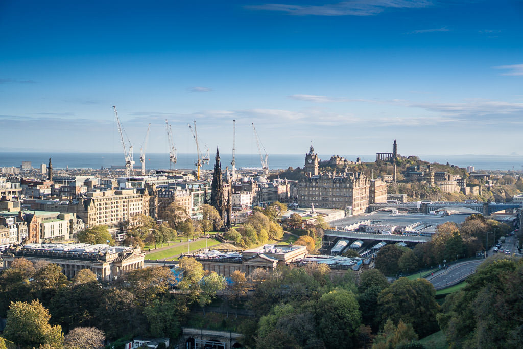 calton hill views of Edinburgh Scotland with cranes and castle