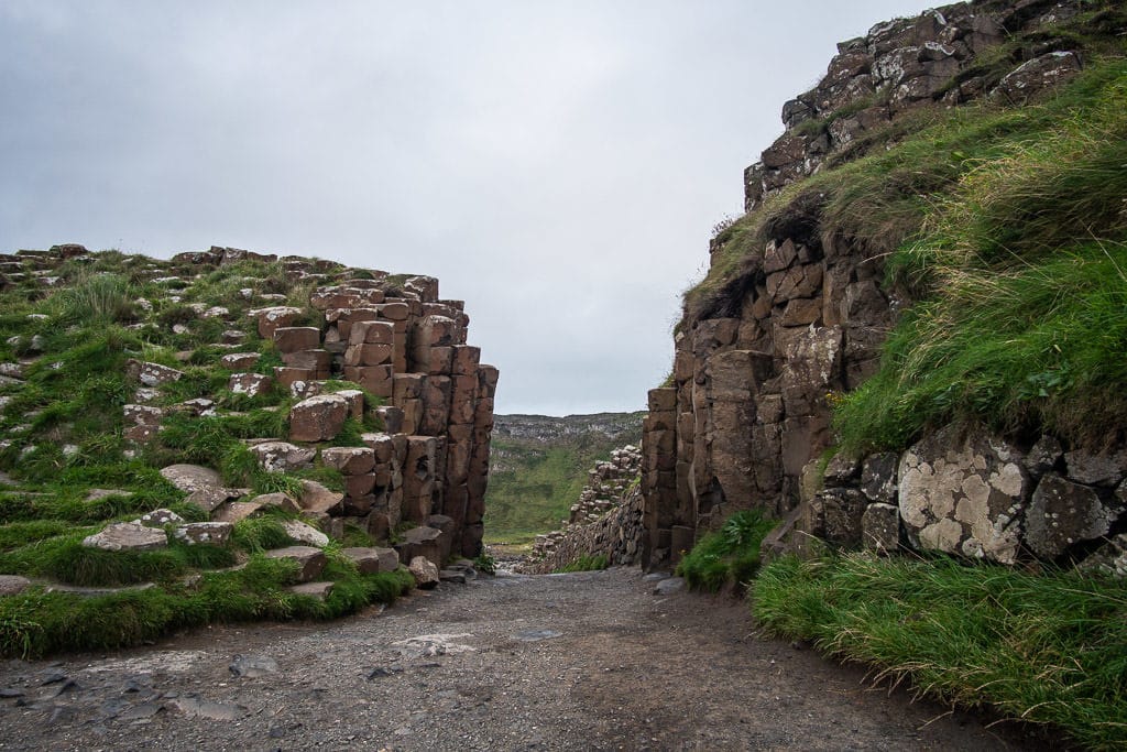 A path between the pillars of the volcanic rock formations at Giant's Causeway