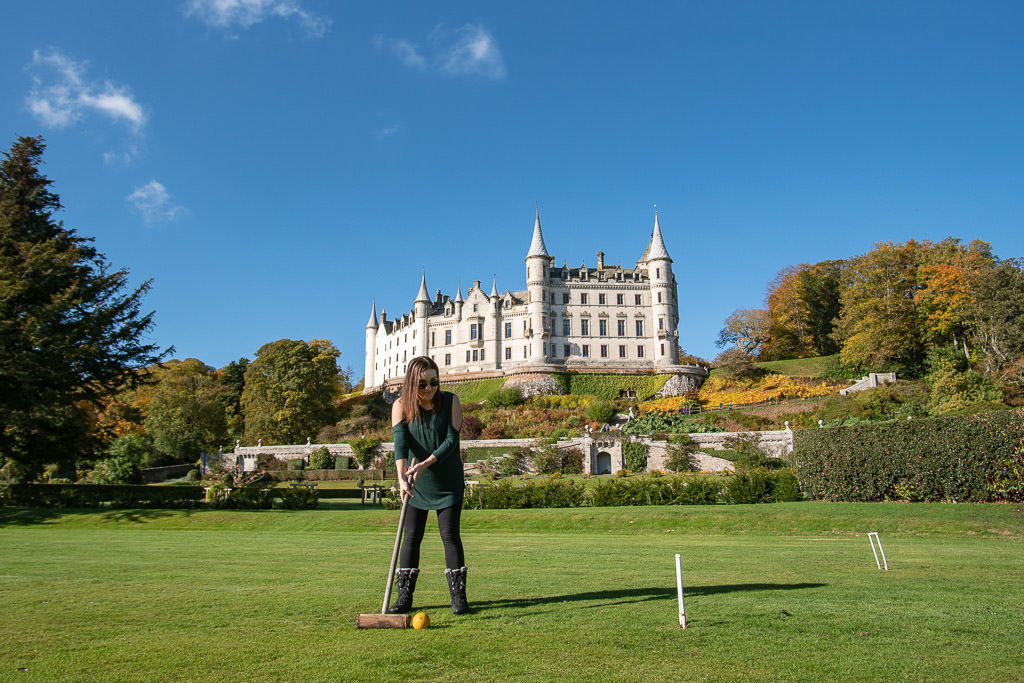 Brooke playing some croquet in the garden with the beautiful Dunrobin Castle behind her