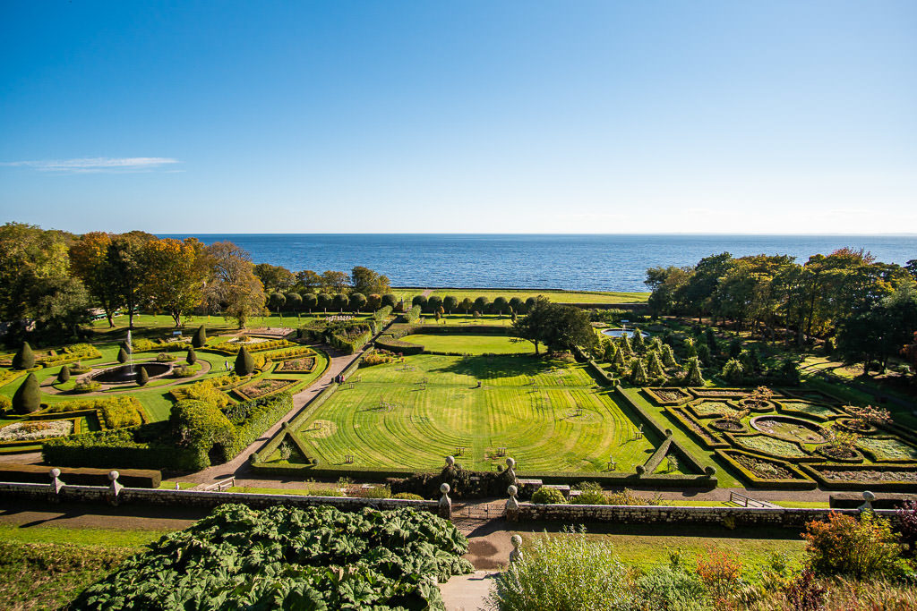 The amazing and beautiful manicured garden at Dunrobin Castle with the sea off in the distance right behind the property