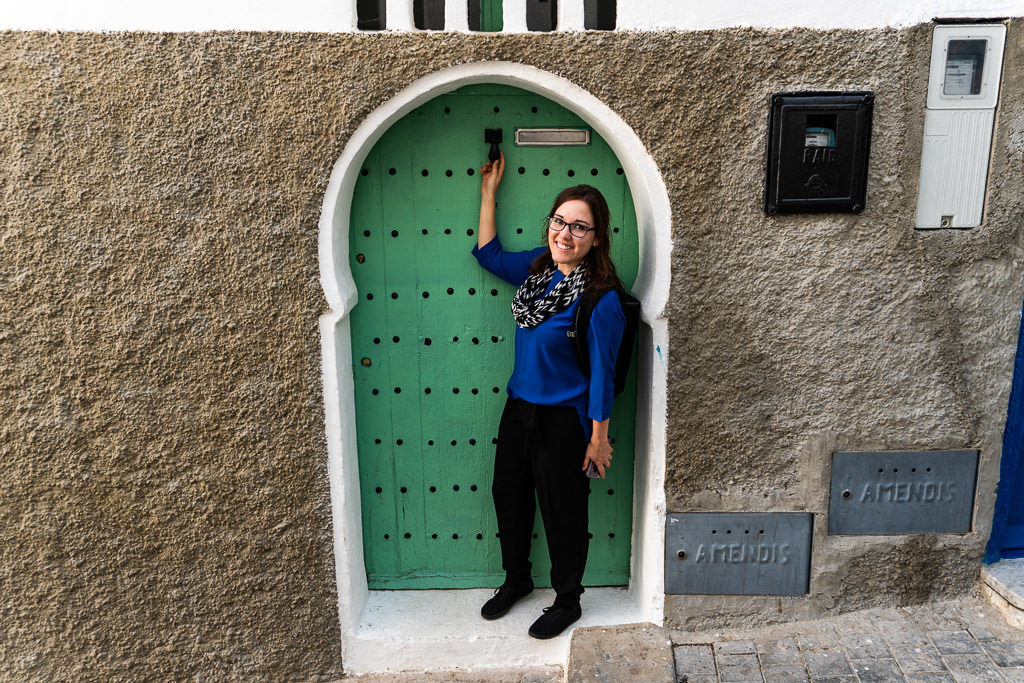 admiring a colorful door in tangier on a day trip to Morocco