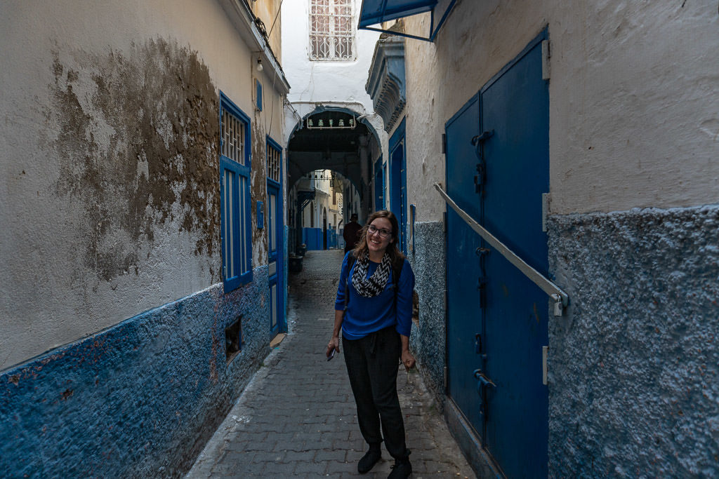 smiling on colorful street in tangier on a day trip to Morocco tour