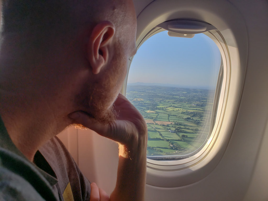 Buddy looking out the plane window at the farmland in Ireland as we approach Belfast