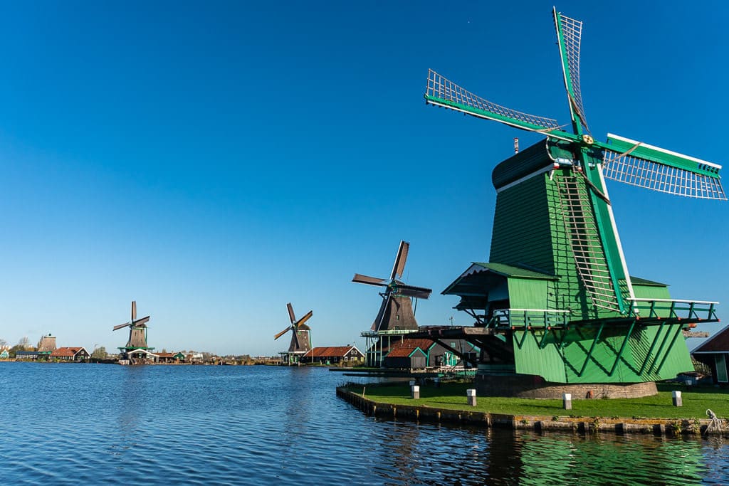 green windmills in zaanse schans on day trip from amsterdam