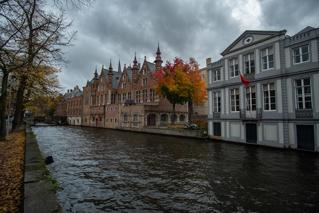 canal with autumn tree colors in bruges belgium