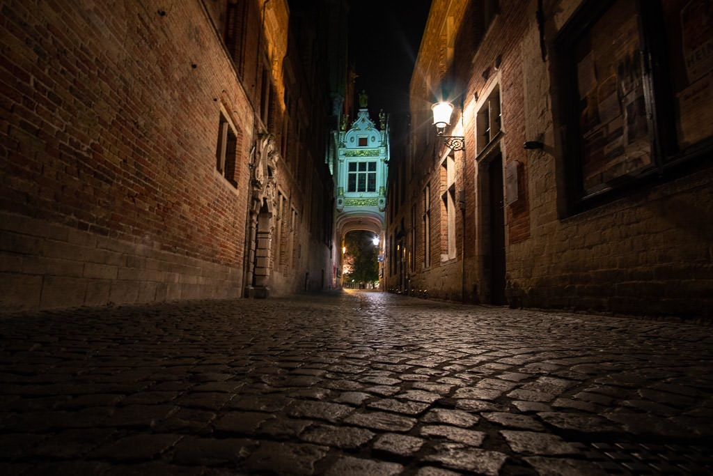 cobblestone sidewalk at night in bruges belgium