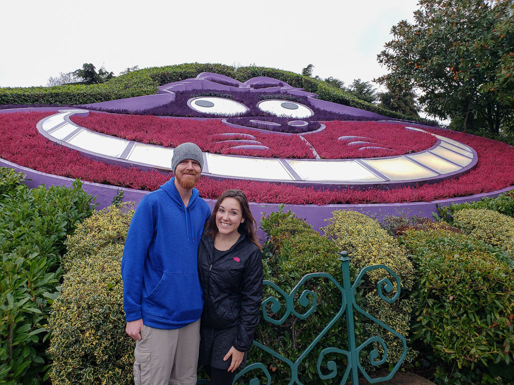 Brooke and Buddy in front of the Cheshire Cat flower garden in the Alice in Wonderland area of disneyland paris