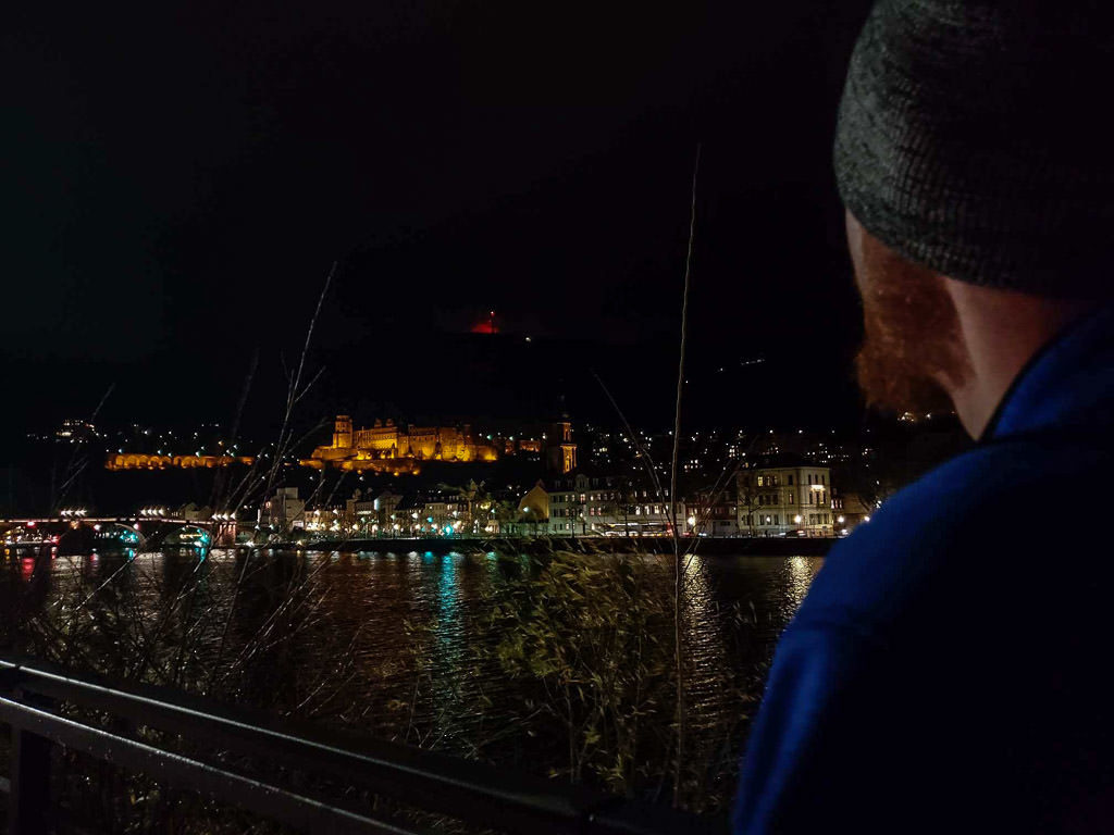 looking at night views of heidelberg castle germany from river