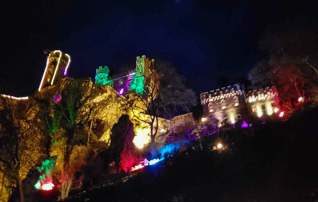 rhine river castle lit up for christmas in germany