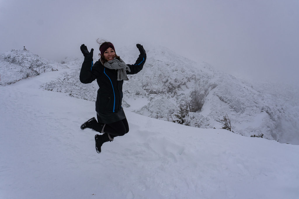 jumping for joy with scenic salzburg austria views on mountain atop Untersberg cable car