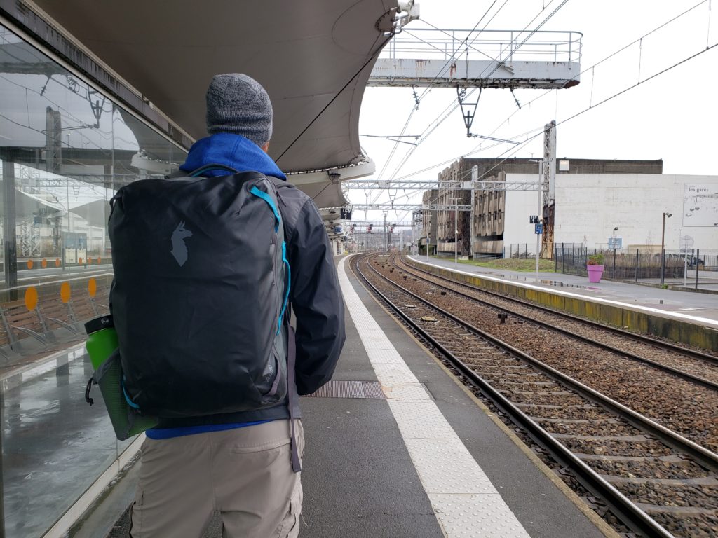 Buddy waiting for train in France during  our long-term house sitting trip through Europe