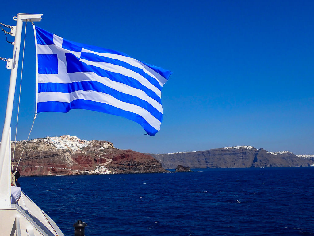 greek flag on ferry with ocean views